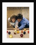 1980s teen couple playing pool by Anonymous
