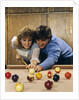 1980s teen couple playing pool by Anonymous