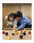 1980s teen couple playing pool by Anonymous
