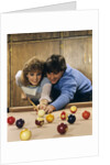 1980s teen couple playing pool by Anonymous