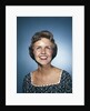 1960s smiling brunette woman in print dress looking up by Anonymous