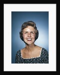 1960s smiling brunette woman in print dress looking up by Anonymous