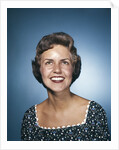 1960s smiling brunette woman in print dress looking up by Anonymous
