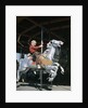 1950s excited boy riding carved wooden carousel merry-go-round horse by Anonymous