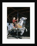 1950s excited boy riding carved wooden carousel merry-go-round horse by Anonymous