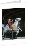 1950s excited boy riding carved wooden carousel merry-go-round horse by Anonymous