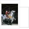 1950s excited boy riding carved wooden carousel merry-go-round horse by Anonymous