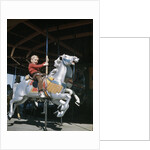 1950s excited boy riding carved wooden carousel merry-go-round horse by Anonymous