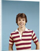 1970s portrait of smiling teenage boy wearing striped rugby shirt looking at camera by Anonymous