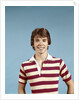 1970s portrait of smiling teenage boy wearing striped rugby shirt looking at camera by Anonymous