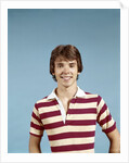 1970s portrait of smiling teenage boy wearing striped rugby shirt looking at camera by Anonymous