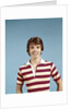 1970s portrait of smiling teenage boy wearing striped rugby shirt looking at camera by Anonymous