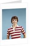1970s portrait of smiling teenage boy wearing striped rugby shirt looking at camera by Anonymous