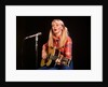 1970s blond young woman ponytails plaid shirt jeans play guitar singing microphone folk singer singers by Anonymous