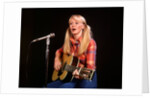 1970s blond young woman ponytails plaid shirt jeans play guitar singing microphone folk singer singers by Anonymous