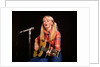 1970s blond young woman ponytails plaid shirt jeans play guitar singing microphone folk singer singers by Anonymous