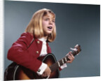 1960s blond teenaged girl singing and playing acoustic guitar by Anonymous