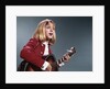 1960s blond teenaged girl singing and playing acoustic guitar by Anonymous
