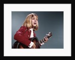1960s blond teenaged girl singing and playing acoustic guitar by Anonymous