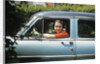 1950s woman driver looking out of car window by Anonymous