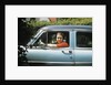 1950s woman driver looking out of car window by Anonymous