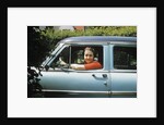 1950s woman driver looking out of car window by Anonymous