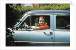 1950s woman driver looking out of car window by Anonymous