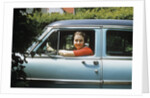 1950s woman driver looking out of car window by Anonymous