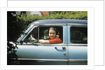 1950s woman driver looking out of car window by Anonymous