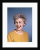 1960s portrait smiling elderly woman wearing orange top laughing looking to side by Anonymous