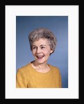 1960s portrait smiling elderly woman wearing orange top laughing looking to side by Anonymous