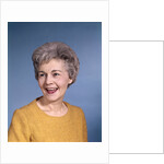 1960s portrait smiling elderly woman wearing orange top laughing looking to side by Anonymous