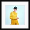 1960s brunette woman short pixie hair style yellow knit sweater earrings holding wine glass by Anonymous