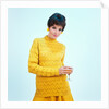 1960s brunette woman short pixie hair style yellow knit sweater earrings holding wine glass by Anonymous