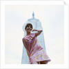 1960s young woman print miniskirt dress summer hat in front empire state building new york city by Anonymous