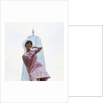 1960s young woman print miniskirt dress summer hat in front empire state building new york city by Anonymous