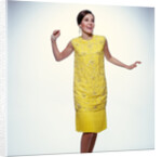 1960s smiling brunette woman modeling yellow sequined cocktail dress clothes by Anonymous
