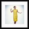 1960s smiling brunette woman modeling yellow sequined cocktail dress clothes by Anonymous