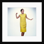 1960s smiling brunette woman modeling yellow sequined cocktail dress clothes by Anonymous