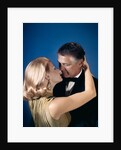 Romantic couple embracing about to kiss husband wife evening dress studio 1970s 1960s by Anonymous