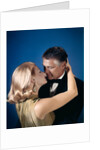 Romantic couple embracing about to kiss husband wife evening dress studio 1970s 1960s by Anonymous