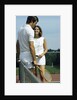 1970s smiling couple standing by net on tennis court holding wood rackets by Anonymous