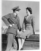 1940s happy couple man wearing army uniform woman sitting on stone wall by Anonymous