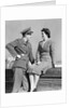 1940s happy couple man wearing army uniform woman sitting on stone wall by Anonymous