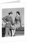 1940s happy couple man wearing army uniform woman sitting on stone wall by Anonymous