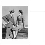 1940s happy couple man wearing army uniform woman sitting on stone wall by Anonymous