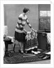 1920s woman packing clothes for travel by Anonymous