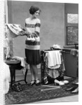 1920s woman packing clothes for travel by Anonymous