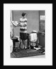 1920s woman packing clothes for travel by Anonymous