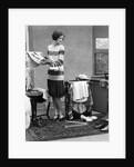 1920s woman packing clothes for travel by Anonymous